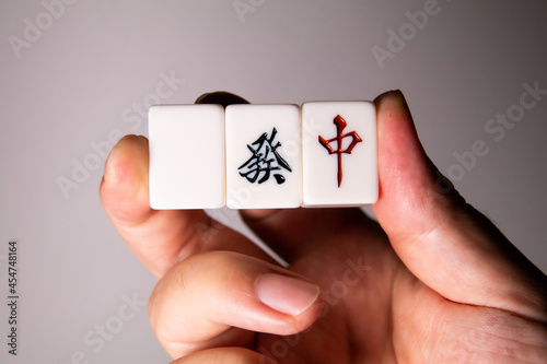 A man holding Mahjong pieces