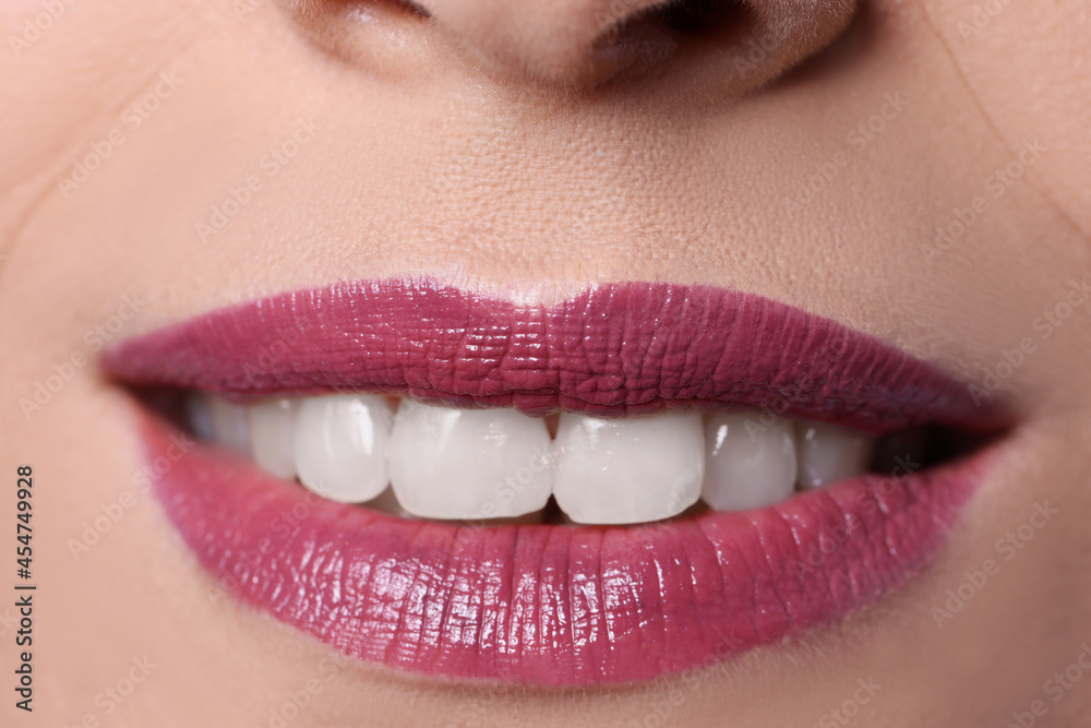 Fototapeta premium Closeup of woman smile with burgundy lips painted with lipstick