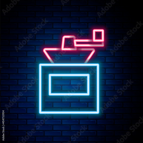 Glowing neon line Manual coffee grinder icon isolated on brick wall background. Colorful outline concept. Vector