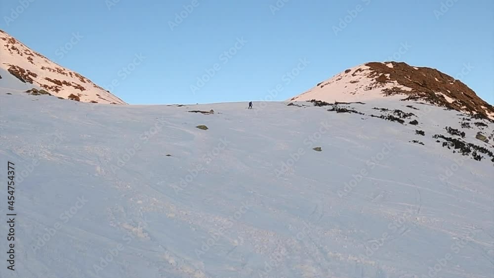 Male freeride skier in the mountains. Concept of discovery, exploration, hiking, adventure tourism, travel. Adventure winter extreme sport.