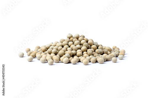 Pile of white pepper seeds (peppercorns) isolated on white background.