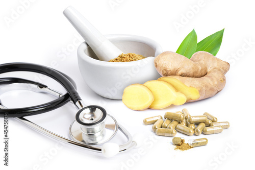 Obraz na plátně Fresh ginger root with slice and capsules with ginger powder and medical stethoscope isolated on white  background