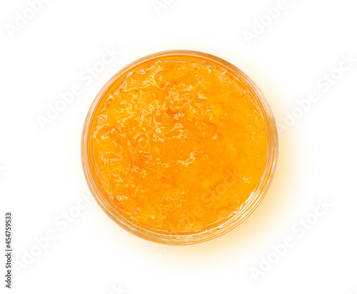 Orange jam in glass bowl isolated on white background. Clipping path. Top view. Flat lay.