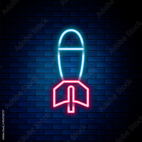 Glowing neon line Rocket launcher with missile icon isolated on brick wall background. Colorful outline concept. Vector