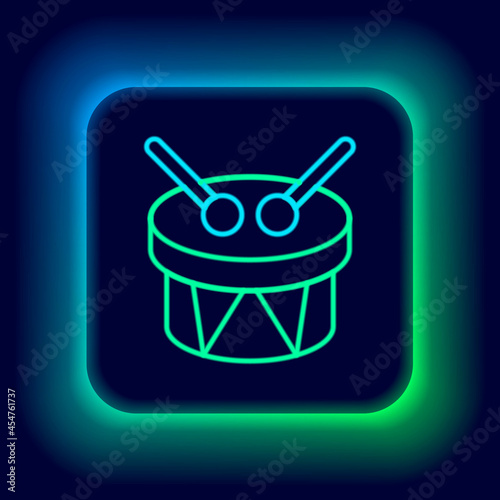 Glowing neon line Musical instrument drum and drum sticks icon isolated on black background. Colorful outline concept. Vector