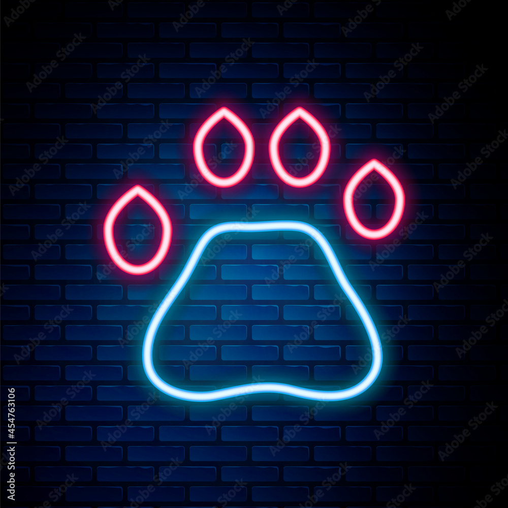 Glowing neon line Bear paw footprint icon isolated on brick wall background. Colorful outline concept. Vector