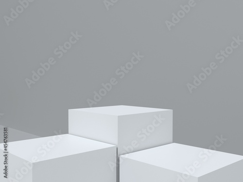 Three white podium and gray wall