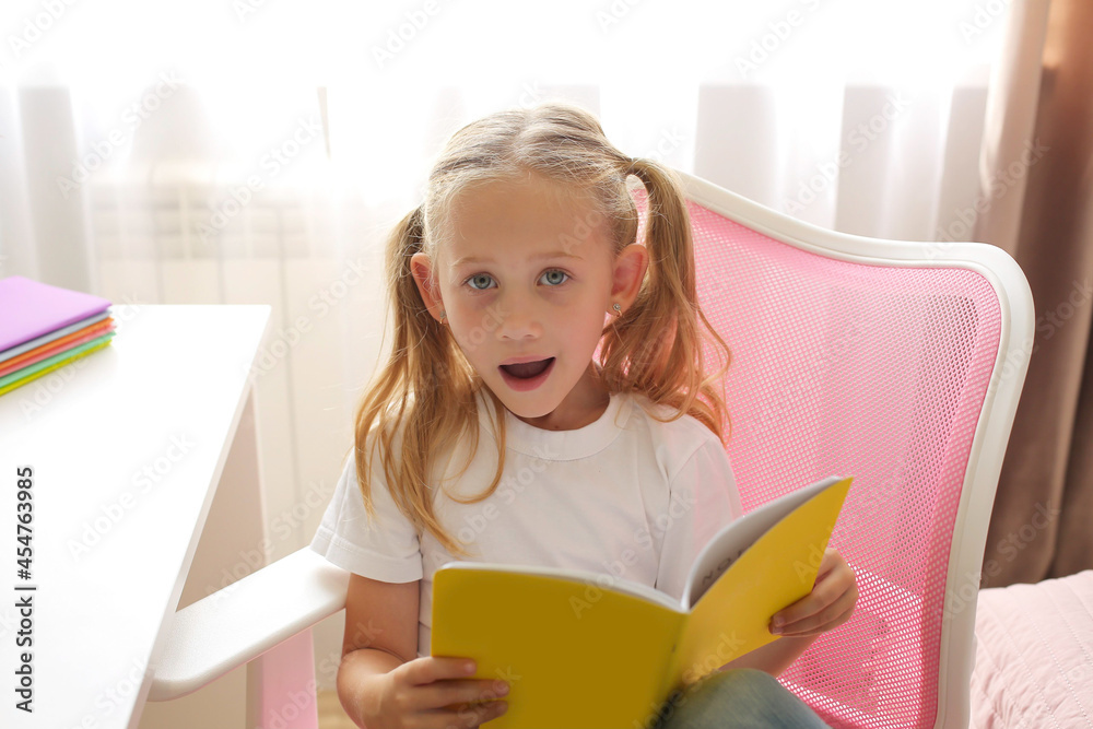 little girl blonde schoolgirl at home teaches lessons online education notebooks globe laptop on desktop little girl blonde schoolgirl at home teaches lessons online education notebooks globe laptop on desktop