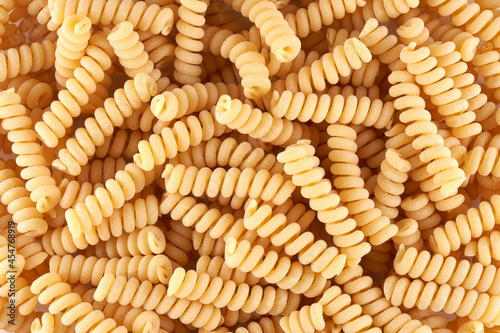 spiral noodles close up background, pasta and macaroni