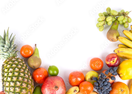 Mix of fresh juicy colorful exotic tropical fruits on white background top view with copy space
