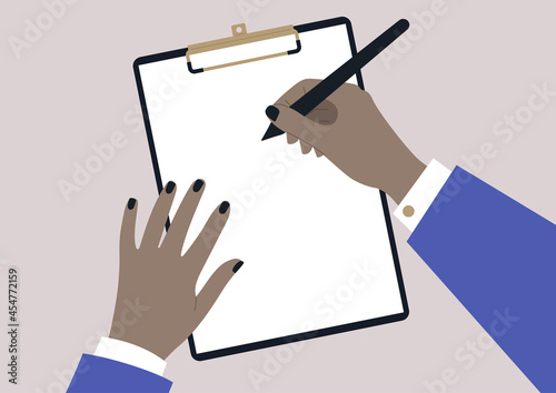 A person with a brown skin complexion writing on a sheet of paper, a clipboard template with copy space