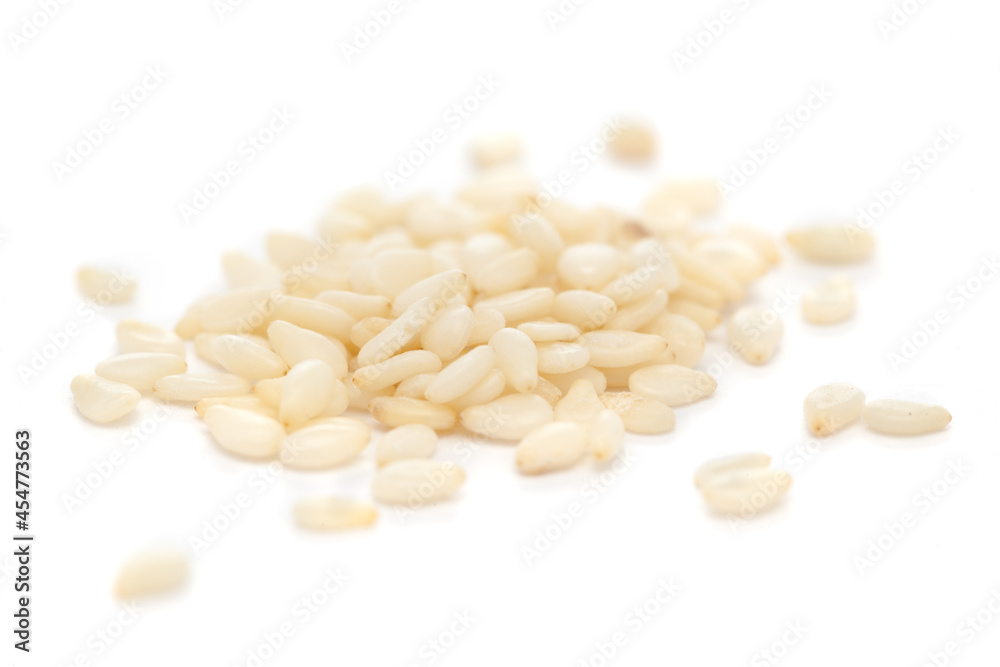 Micro close-up and details of Organic Indian White Sesame seeds(Sesamum indicum) polished or white Til without shell isolated over white background. Micro close-up and details of Organic Indian White Sesame seeds(Sesamum indicum) polished or white Til without shell isolated over white background.