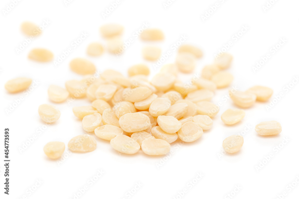 Micro close-up and details of Organic Indian splitted white urad dal (Vigna mungo) isolated over white background. Micro close-up and details of Organic Indian splitted white urad dal (Vigna mungo) isolated over white background.