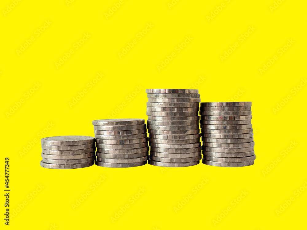 Stack of coins on Yellow background. Money income concept. Investment,  profit, saving.