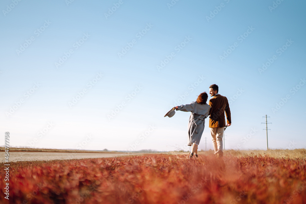 Beautiful young couple walking and hugging outdoors. Autumn. The concept of youth, love and lifestyle. Travel and adventure. Beautiful young couple walking and hugging outdoors. Autumn. The concept of youth, love and lifestyle. Travel and adventure.