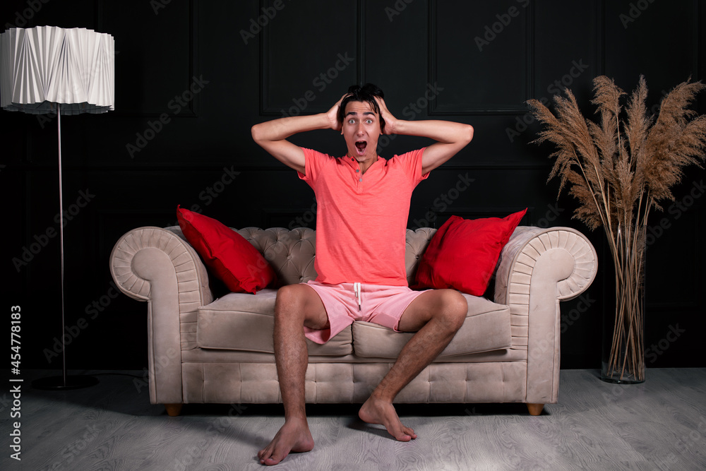 Obraz premium Tired young guy is resting on the couch at home.