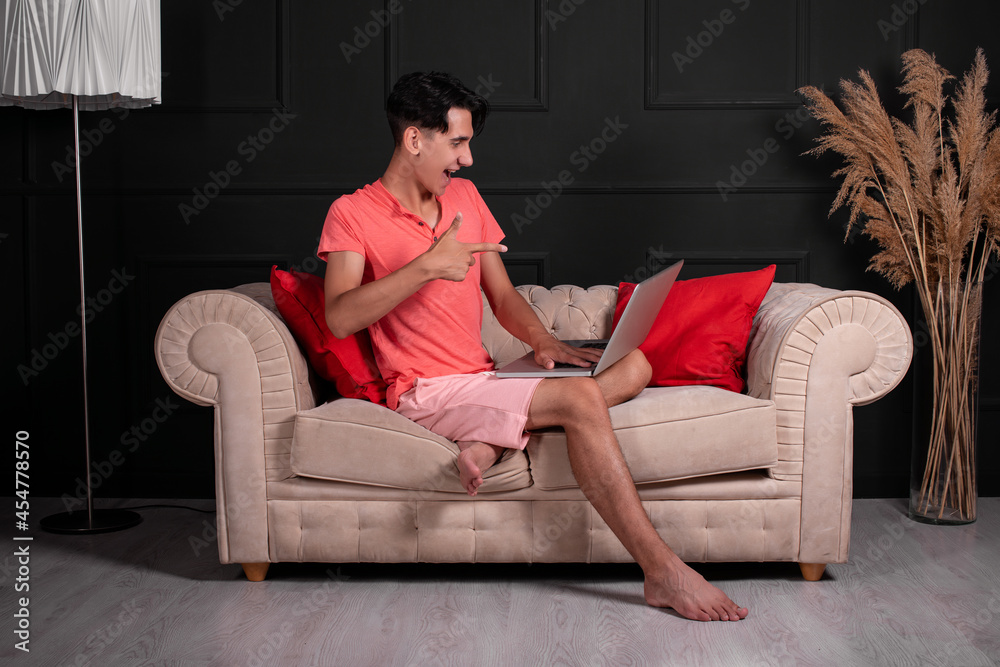 A cute and funny guy will erase a movie on his laptop. The man is conducting an online video call. Reading a report on a computer. A cute and funny guy will erase a movie on his laptop. The man is conducting an online video call. Reading a report on a computer.