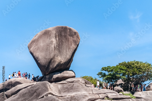 Similan Islands, Thailand - February 9, 2017: Sail Rock. The bay in the Similan Islands overcrowded with people on a blue background
