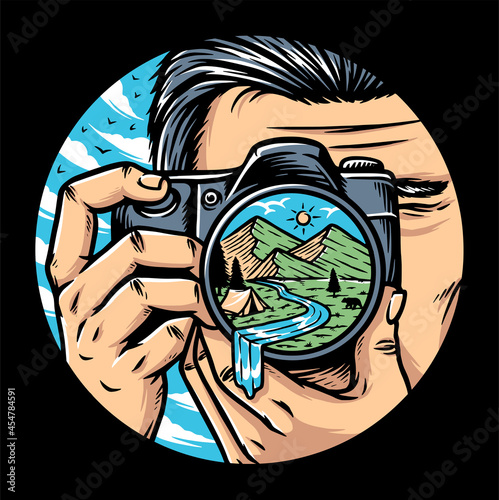 Man photographer with camera taking photo of mountains