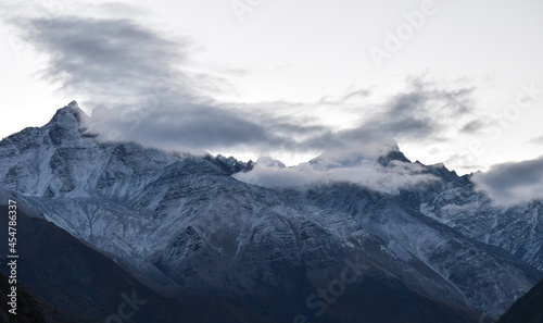 clouds above snow covered mountains.