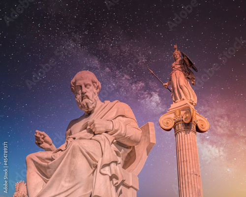 Plato, the ancient Greek philosopher and Athena goddess, marble statues under the dramatic night sky full of stars