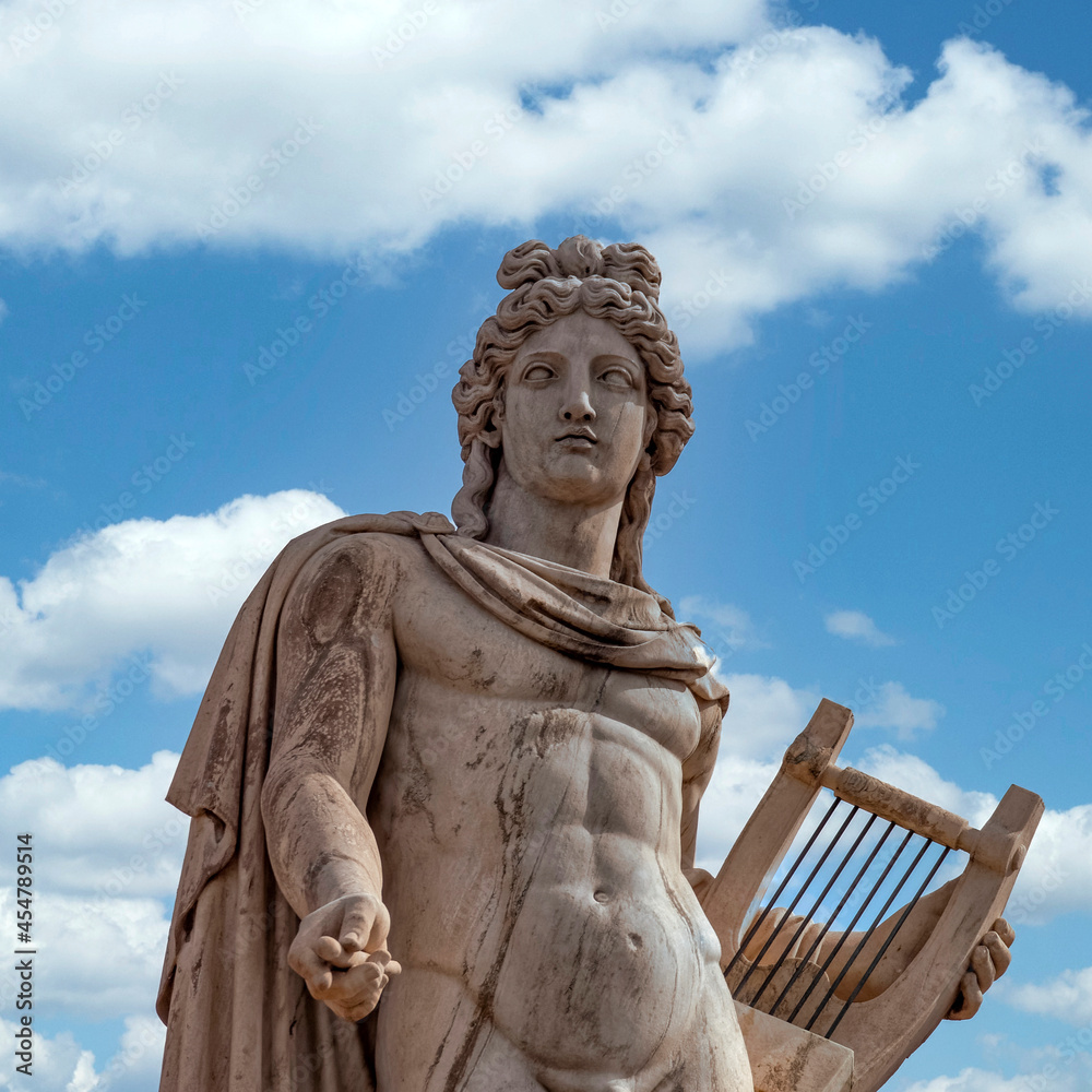 Apollo ancient Greek god statue and blue sky with some white clouds