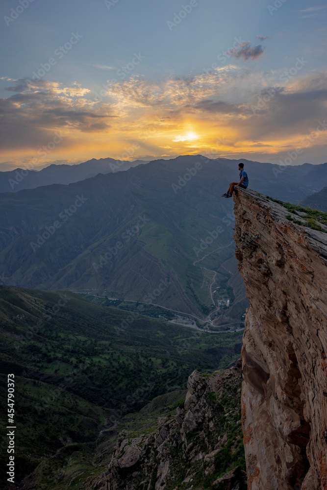 Man on the top of the mountain during sunset Man on the top of the mountain during sunset