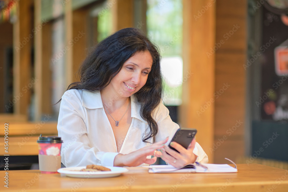Cheerful elegant elderly woman chat with friends on a smartphone. Dating sites for seniors concept. Cheerful elegant elderly woman chat with friends on a smartphone. Dating sites for seniors concept.