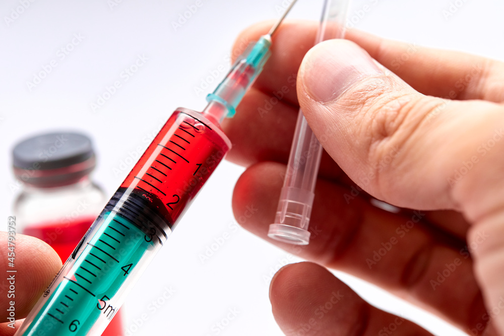 Vaccine in vial with syringe Vaccine in vial with syringe