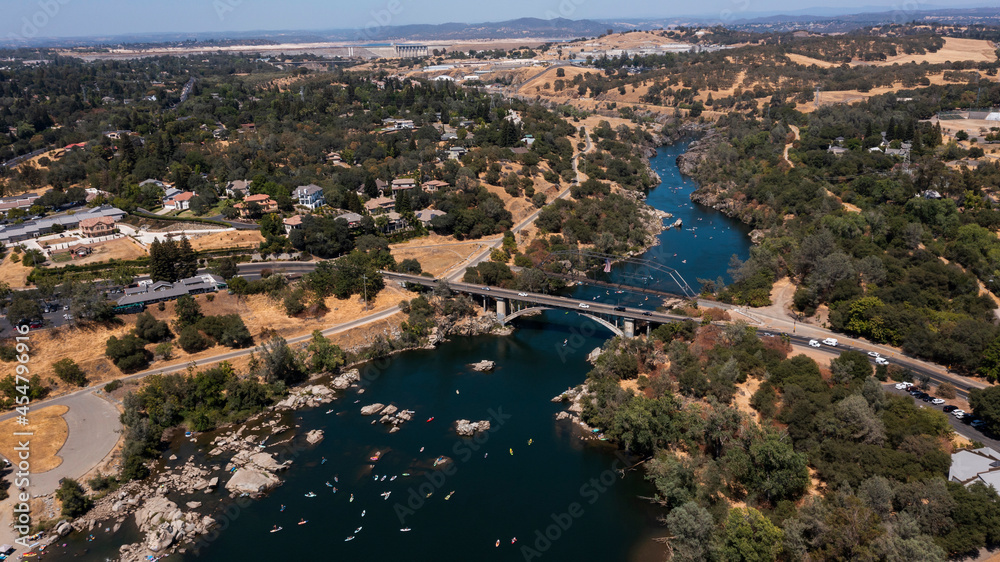 Daytime aerial view of the American River and the city of Folsom, California, USA.