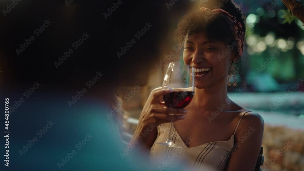 beautiful african american woman enjoying dinner date flirting with man couple drinking wine making toast celebrating romantic evening together 4k