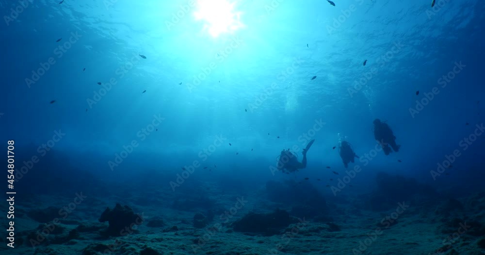 scuba divers coming down descending scenery underwater sun beams and rays sun shine silhouette scenery scuba divers coming down descending scenery underwater sun beams and rays sun shine silhouette scenery