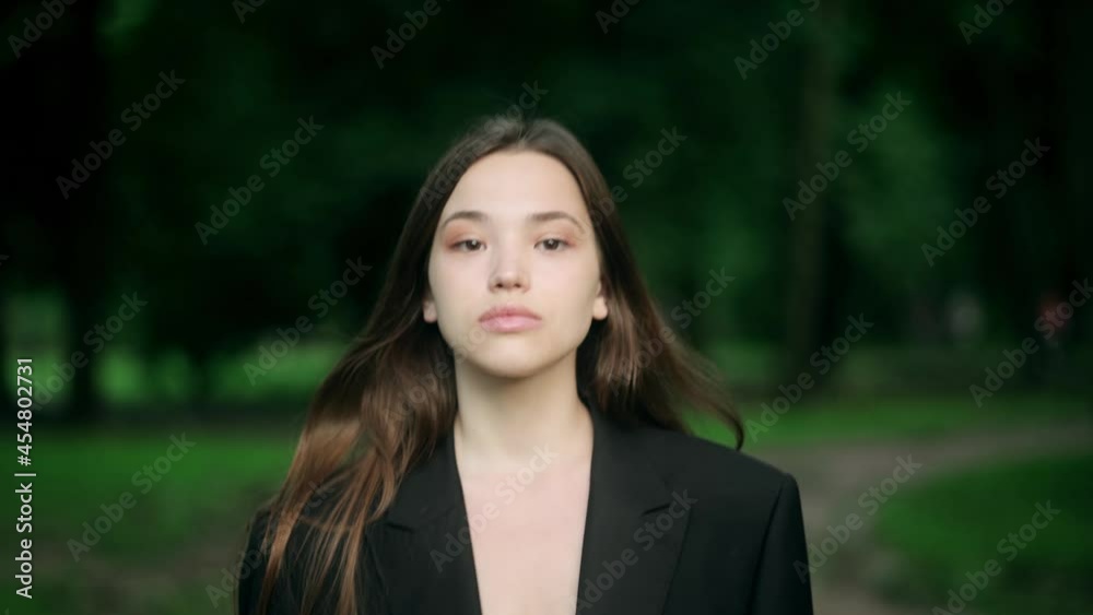 Portrait of an attractive brunette woman in the park on a sunny day and smiling. The face of a happy beautiful woman in summer outdoor Portrait of an attractive brunette woman in the park on a sunny day and smiling. The face of a happy beautiful woman in summer outdoor