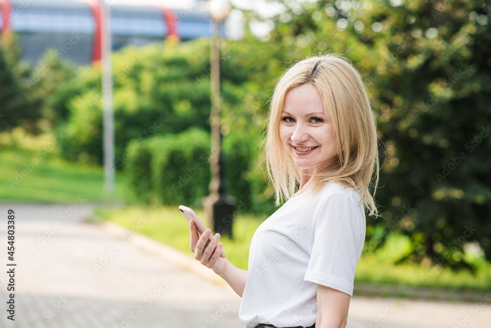 Portrait of a beautiful and caucasian woman. Smartphone using. Business concept. Portrait of a beautiful and caucasian woman. Smartphone using. Business concept.