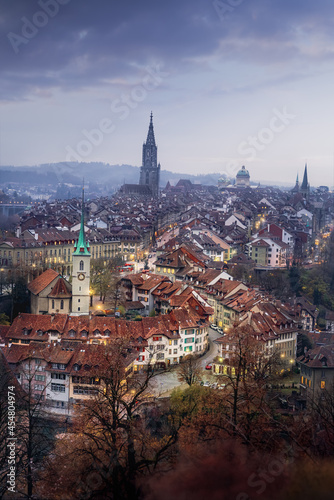 Illuminated view of Bern Old Town at sunset with Bern Minster and Nydeggkirche Church - Bern, Switzerland