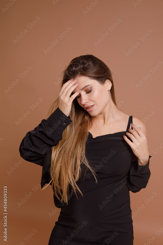 Beautiful pregnant young woman in studio on beige background Beautiful pregnant young woman in studio on beige background