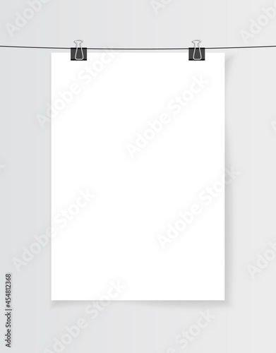 Blank white A4 paper hanging on binder clips with shadow. Empty poster layout in the gallery. Jpeg mock up illustration. Vertical template sheet isolated on a gray background