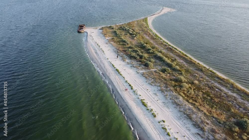 Aerial of the paradise island in the dawn. The flooded ship on the beach at sunrise.  Video from the drone. Solitude with nature.