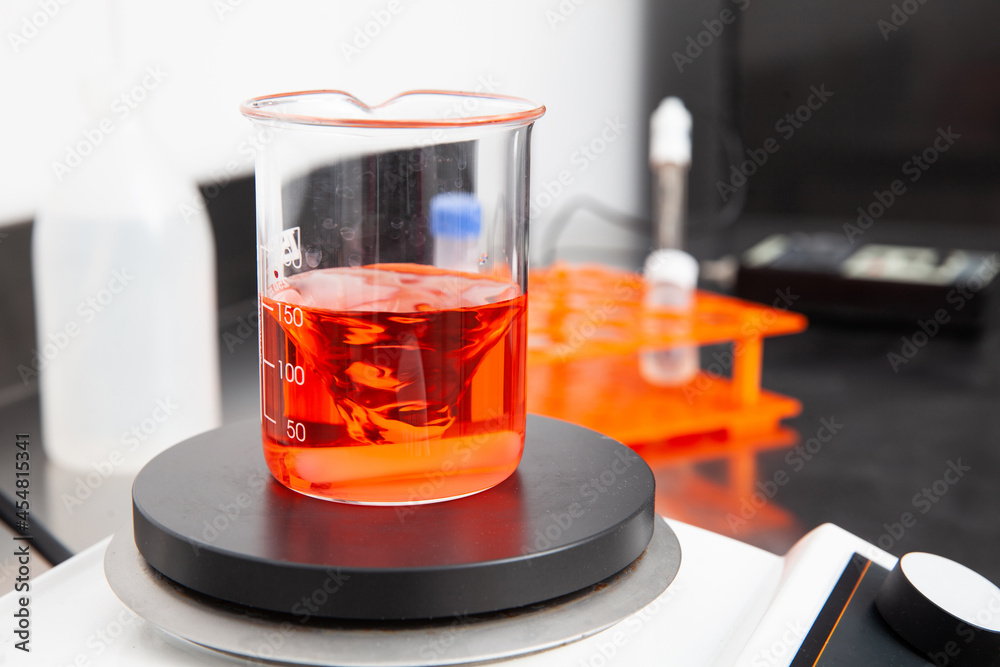 stirrer mixing a liquid in a beaker at laboratory Stock Photo