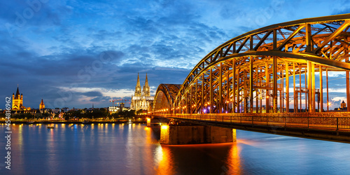 Cologne Cathedral city skyline and Hohenzollern bridge with Rhine river in Germany at twilight panoramic view