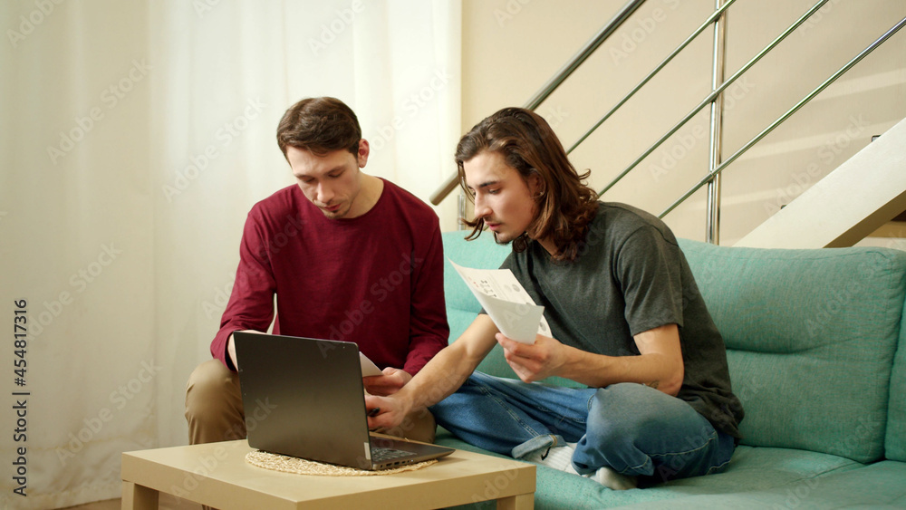 Two men are discussing and looking through documents Two men are discussing and looking through documents