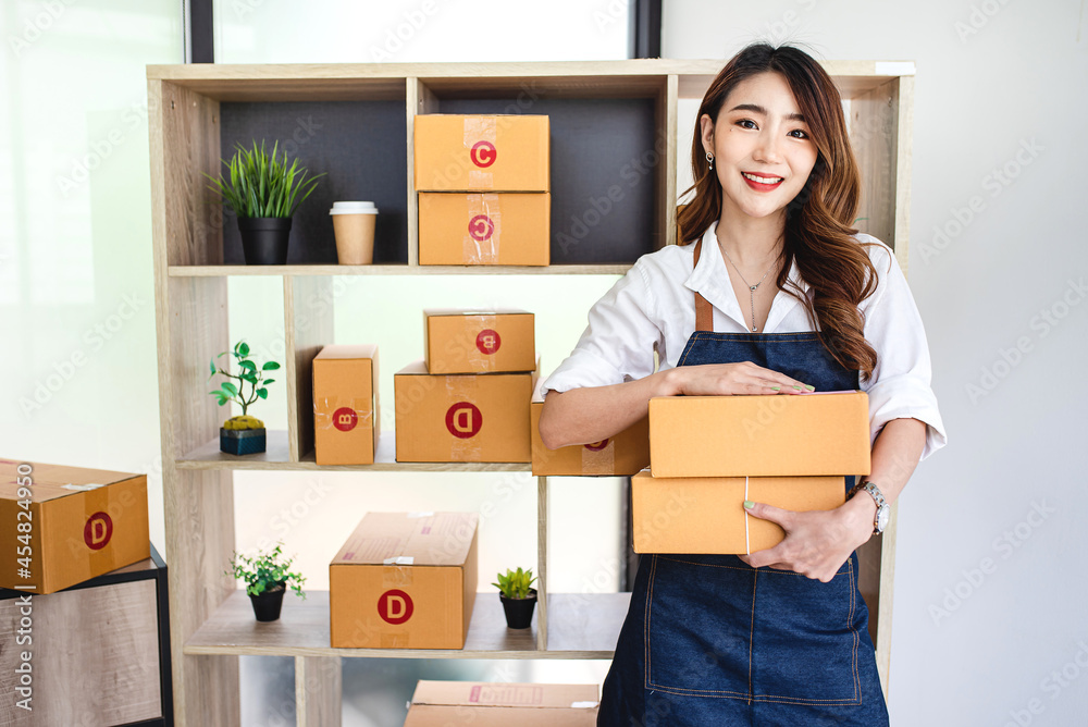 businesswoman start small business and successful SME entrepreneurs A woman works from home delivering parcels online. SME delivery concept and packaging