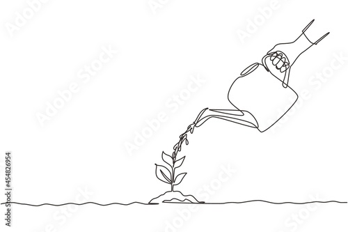 Single continuous line drawing hand holding watering can watering plant at ground. Earth day save environment concept. Growing seedling forester planting. Dynamic one line draw graphic design vector photo