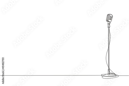 Single continuous line drawing vintage microphone isolated on white background. Old technology stand microphone for singer at classic musical show. One line draw graphic design vector illustration
