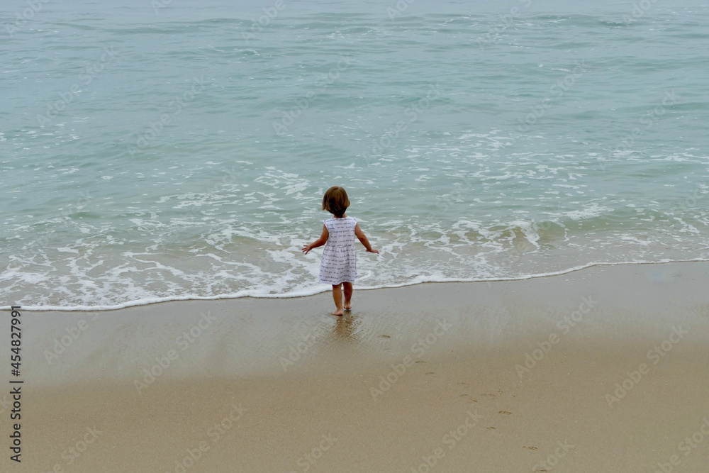 little girl playing on the beach
