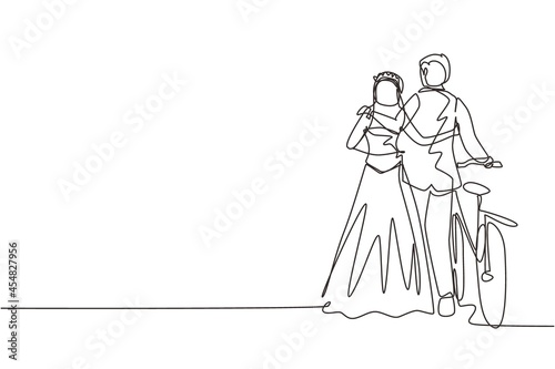 Single one line drawing back view of cute romantic married couple with bicycle walking in park on sunny autumn day. Man and woman in love with wedding dress. Continuous line draw design graphic vector