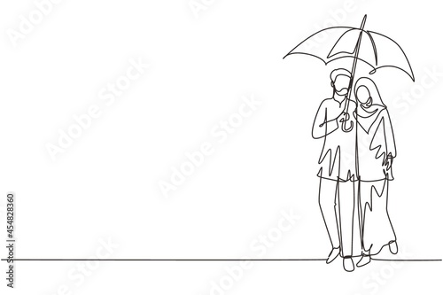 Single continuous line drawing Arabian couple man woman, girl and boy walking holding umbrella under rain smiling hugging. Romantic couple at rainy autumn weather. One line draw graphic design vector