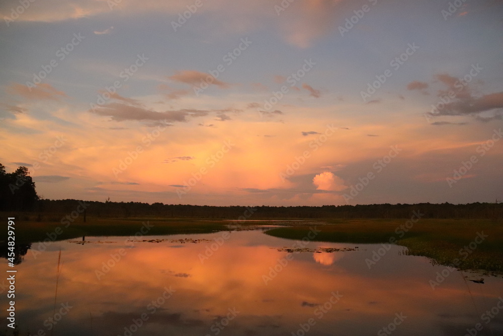 Romantic sunset sunrise on peaceful waters lake