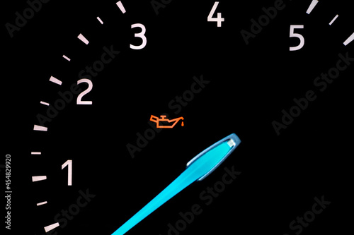 Car engine oil pressure warning light on dashboard. Vehicle repair, maintenance, service and oil change concept