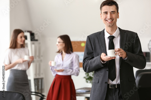 Businessman drinking coffee in office